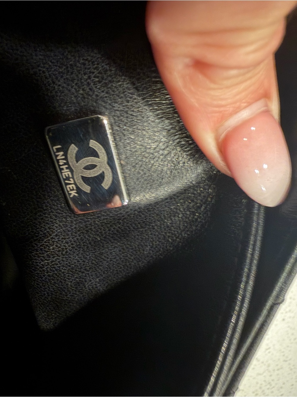 CHANEL Black Leather Interior with Silver Logo Plaque